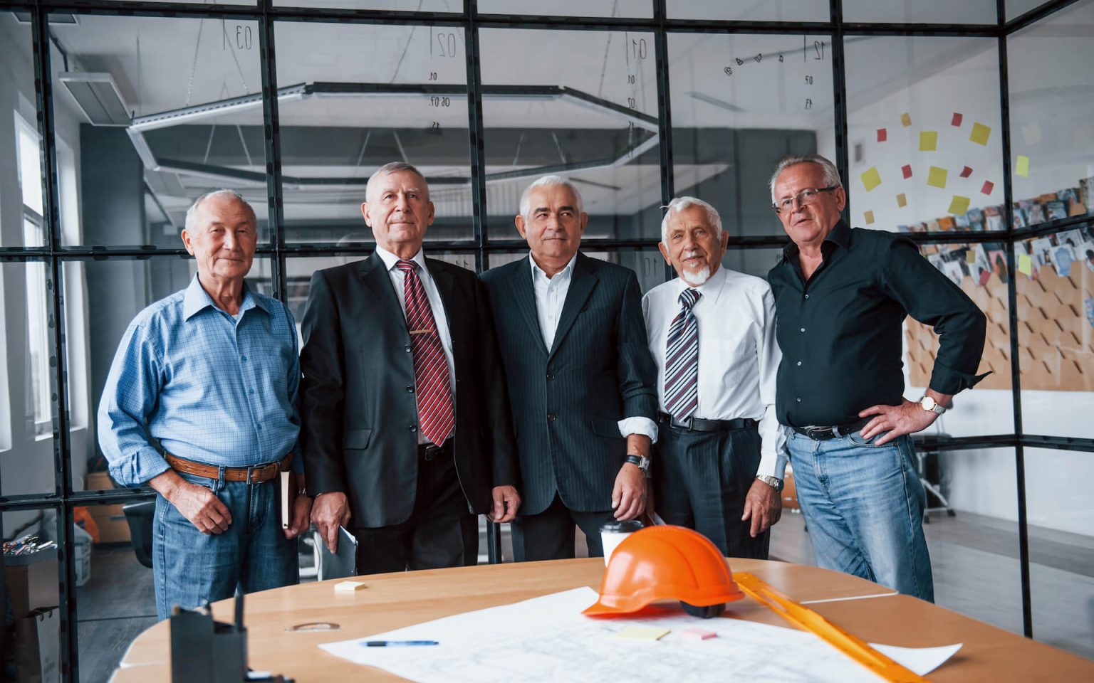 aged-team-of-elderly-businessman-architects-stands-2021-08-28-22-30-33-utc.jpg